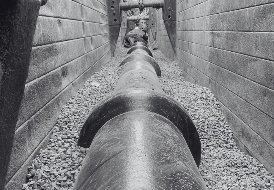 Workers installing a large-diameter GRP water pipe